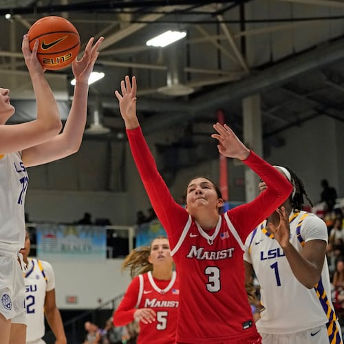 LSU forward Kate Koval, left, looks to shoot a jump shot over Marist guard Justine Henry (3) during the second quarter of an NCAA college basketball game at the Paradise Jam tournament Friday, Nov. 28, 2025, in St. Thomas, U.S. Virgin Islands. (Bill Kiser/The Virgin Islands Daily News via AP)