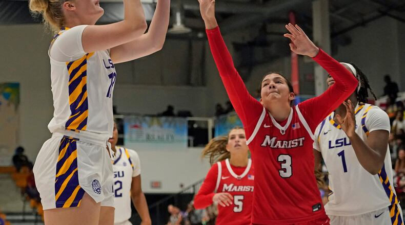 LSU forward Kate Koval, left, looks to shoot a jump shot over Marist guard Justine Henry (3) during the second quarter of an NCAA college basketball game at the Paradise Jam tournament Friday, Nov. 28, 2025, in St. Thomas, U.S. Virgin Islands. (Bill Kiser/The Virgin Islands Daily News via AP)