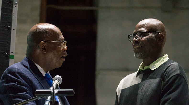 01/08/2020 -- Atlanta, Georgia -- Fulton County District Attorney Paul L. Howard (left) presents Darell Hall (right) of Lithonia a job opportunity during the introduction ceremony for the Fulton County District Attorney's office Conviction Integrity Unit at Tyler Perry Studios in Atlanta, Wednesday, January 8, 2020. The Conviction Integrity Unit will review psst convictions for credible claims of actual innocence, wrongful conviction, and, where feasible, sentencing inequities. Darrell Hall, the first case taken up by the CIU, received a re-sentencing for his conviction. (ALYSSA POINTER/ALYSSA.POINTER@AJC.COM)