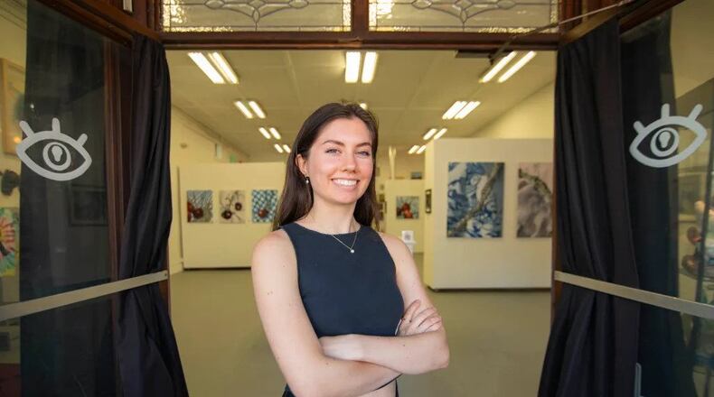 Artist Lucy Luckovich in the doorway of Cat Eye Creative. (Photo Courtesy of Isadora Pennington)