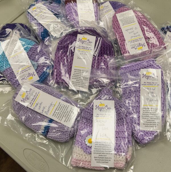 Happy Cap volunteers knit caps for patients at the Wellstar West Cobb Medical Center in Marietta. Kathy DeJoseph, founder of Happy Caps, was touched when a woman made her a knit cap as she began chemo. Later, when she looked to find a fulfilling way to fill her years she decided to begin knitting hats for other patients. With an army of volunteers, she has pulled together 44,000 plus caps for cancer patients. (Phil Skinner for the AJC)