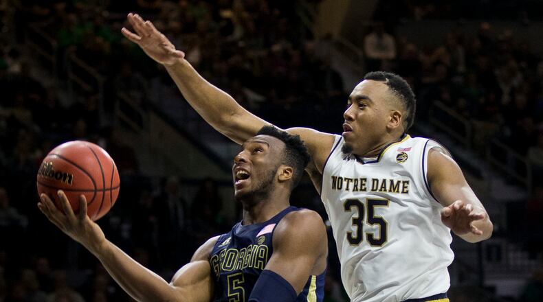 Georgia Tech's Josh Okogie (5) goes up to shoot as Notre Dame's Bonzie Colson (35) defends during the first half of an NCAA college basketball game Saturday, Dec. 30, 2017, in South Bend, Ind. (AP Photo/Robert Franklin)