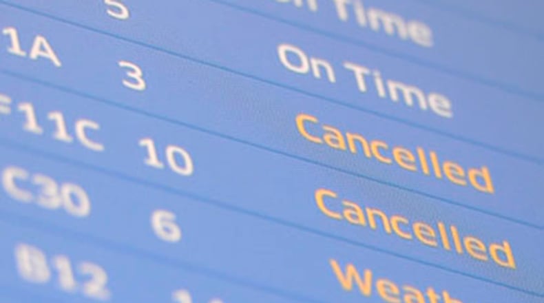 Flight information boards display canceled and delayed flights. (AP Photo/Brian Kersey)