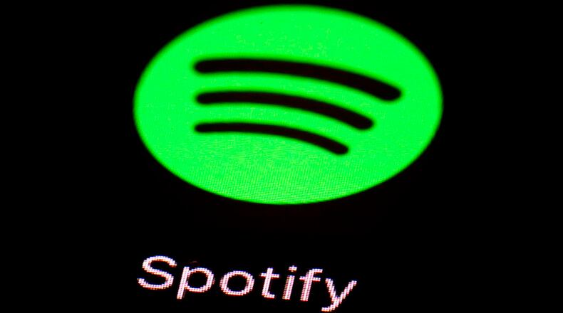 FILE- This March 20, 2018, file photo shows the Spotify app on an iPad in Baltimore. Spotify is backpedaling on its recently announced anti-hate policy after some music industry players criticized it. The company said in blog post on Friday, June 1 that when it announced the policy on May 10 it "created confusion and concern" and that Spotify "didn't spend enough time getting input from our own team" (AP Photo/Patrick Semansky, File)