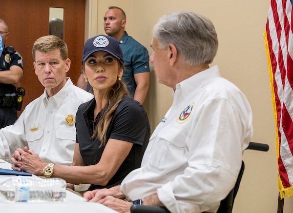 Homeland Security Secretary Kristi Noem and Gov. Greg Abbott, discuss the ongoing efforts for recent flooding along the Guadalupe River during a news conference in Ingram, Texas, on Saturday, July 5, 2025, as Texas Division of Emergency Management Chief, Nim Kidd, left, looks on. (AP Photo/Rodolfo Gonzalez)