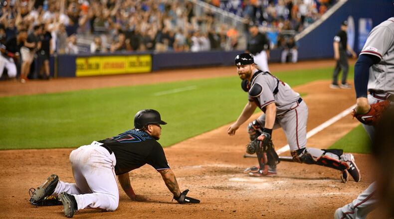 Harold Ramirez of the Miami Marlins scores the game-winning run in the 10th inning against the Braves. (Photo by Mark Brown/Getty Images)