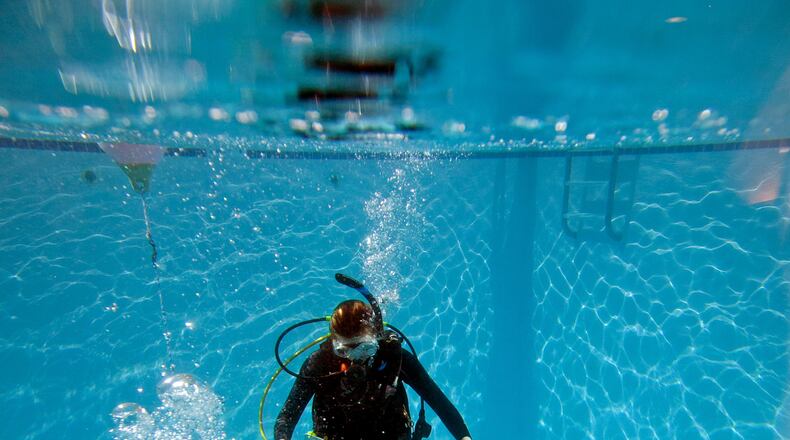 Sydney Aitkens, 16, of Macon, practices her scuba diving skills during Part 2 of the scuba diving class for certification at SeaVentures Scuba and Swim, Saturday, January 30, 2016, in Alpharetta, Ga.