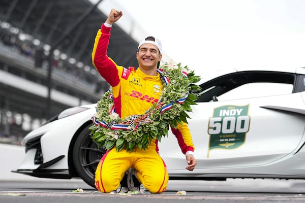 Alex Palou, of Spain, celebrates on the Yard of Bricks on the start/finish line after winning the Indianapolis 500 auto race at Indianapolis Motor Speedway in Indianapolis, Sunday, May 25, 2025. (AP Photo/AJ Mast)