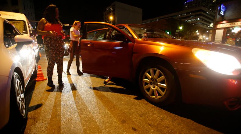 Mieola Easter, left, and Jessica Vacek exit a Lyft on 4th Street Friday, May 6, 2016. (Stephen Spillman / for American Statesman)