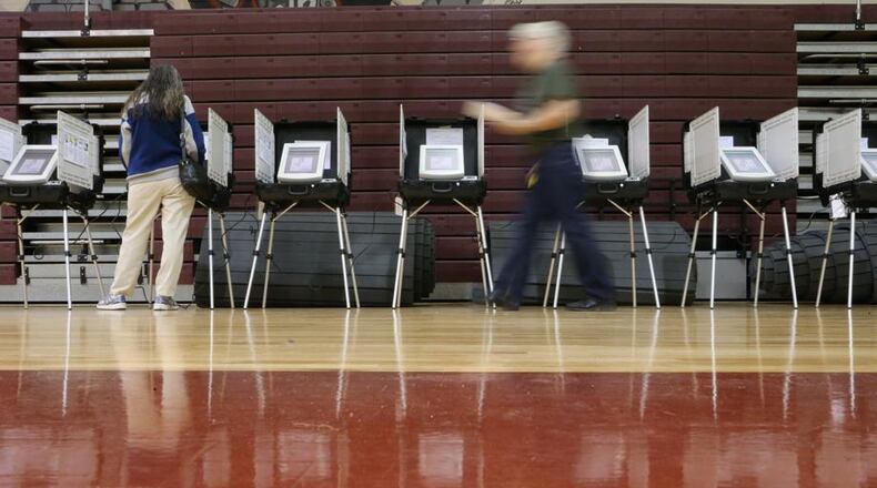 Woodstock residents will have to visit two polling places Nov. 6 to vote in both the statewide general election, and the municipal special election to roll back to 11 a.m. the Sunday serving hour for alcohol, the city advises. AJC FILE