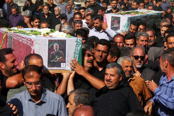 Mourners carry the flag-draped coffins of Ali Hatefi (left) and Abbas Zarei (rright) who were reportedly killed in Israeli strikes during their funeral in the city of Asadabad, Iran, Monday, June 16, 2025. (AP Photo/Abdolrahman Rafati/Tasnim News Agency)