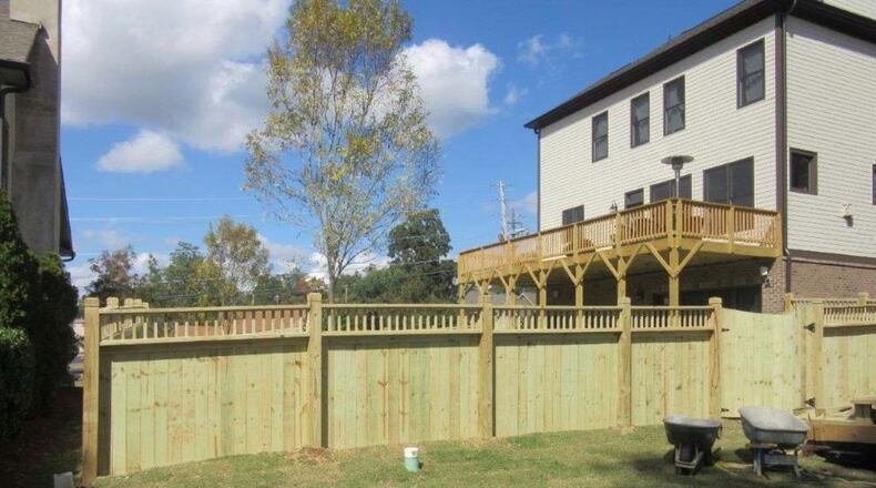This 6-foot tall fence at 135 Autry St. will need to be reduced to four feet tall or removed to comply with a Norcross city ordinance. Courtesy City of Norcross