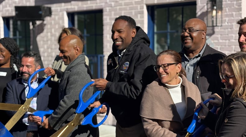 Mayor Andre Dickens cuts the ribbon during the opening ceremony for a new apartment building on Bonaventure Avenue in Atlanta that provides studio apartments for homeless people. Tuesday, Dec. 3, 2024. (Matt Reynolds/ AJC)