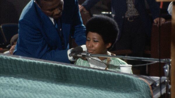 Aretha Franklin's father, C.L. Franklin, dabs the sweat from her face during the performance.