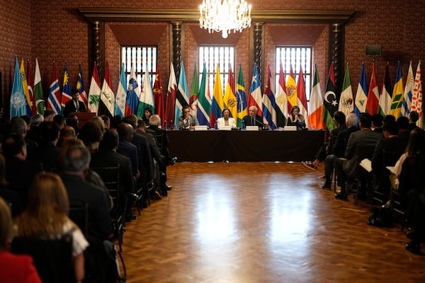Riyad Mansour, Palestinian U.N. ambassador, top, second from right, speaks in Bogota, Colombia, Tuesday, July 15, 2025, during a two-day conference to address the Israel-Hamas war and Israel's military actions in Gaza. Second from left at the table is Colombian Foreign Minister Rosa Yolanda Villavicencio. At far right at table is U.N. Special Rapporteur for the Occupied Palestinian Territories Francesca Albanese. At far left at table is Zane Dangor, South Africa's Foreign Minister. (AP Photo/Fernando Vergara)