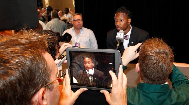 FILE - In this July 17, 2014, file photo, Georgia tailback Todd Gurley speaks to the media at the Southeastern Conference NCAA college football media days in Hoover, Ala. Gurley was emerging as the clear favorite in the Heisman Trophy race, a running back who already produced plenty of signature moments with his myriad talents. Now, it's not known when _ or if _ Gurley will take another handoff for Georgia. The star of the 13th-ranked Bulldogs was suspended indefinitely on Thursday, Oct. 9, 2014, while the school investigates an alleged violation of NCAA rules. (AP Photo/Butch Dill, File)