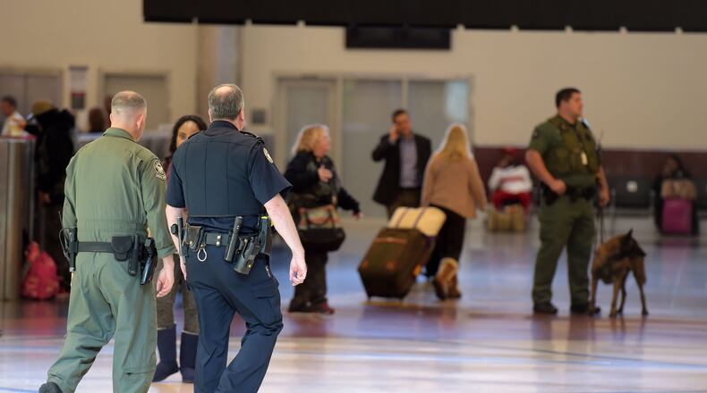Police patrol domestic terminal atrium at Hartsfield-Jackson on Monday, November 16, 2015. KENT D. JOHNSON/KDJOHNSON@AJC.COM