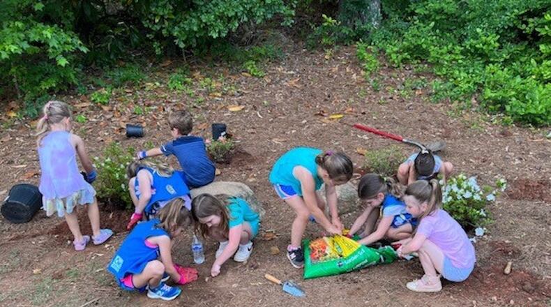 Eight young girls from Daisy Troop 22074 (and one younger brother) worked together to plant two large and three smaller azalea bushes at Friendship Community Park in Milton. (Courtesy City of Milton)