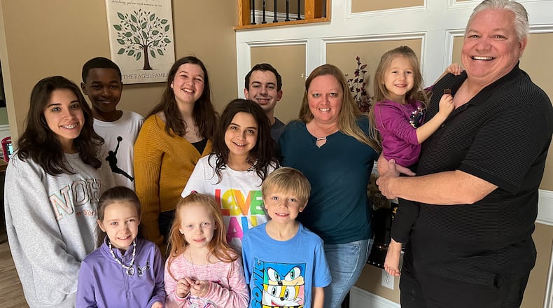 Lisa Rager knows well the hurdles to obtaining services for foster kids. She and her husband, Wes, have cared for more than 100 foster children and adopted 11 of them, many of whom are pictured. Rager says one child waited more than a year for an appointment to see a specialist doctor. (Andy Miller/KHN)