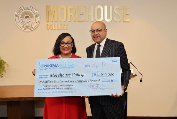 U.S. Rep. Nikema Williams, D-Ga., and Morehouse College President David A. Thomas pose with a ceremonial check with funds for Morehouse's Higher Education in Prisons Program. (Courtesy of David Collins)