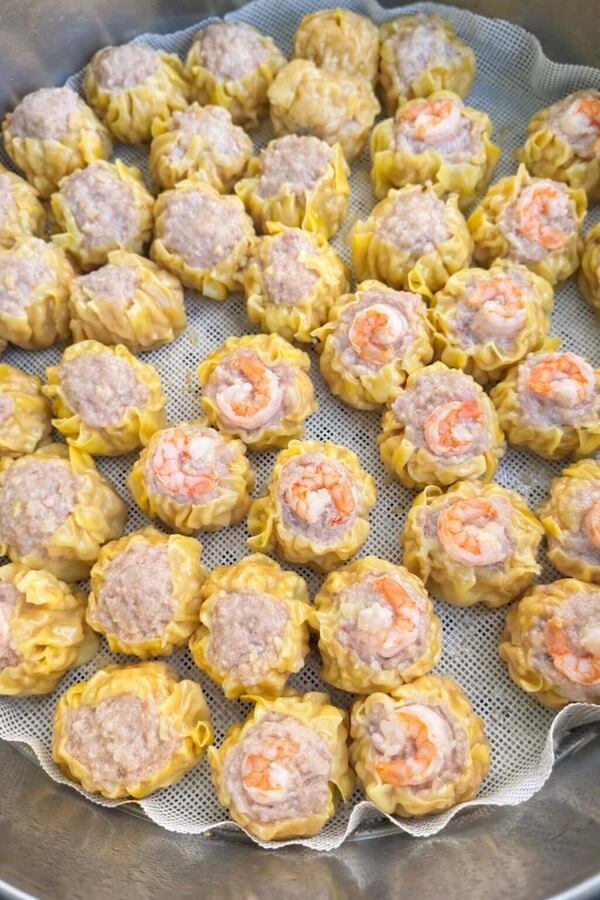 A plethora of pork and shrimp shumai, which looks like a pastry shell filled with pate and garnished with cocktail shrimp.