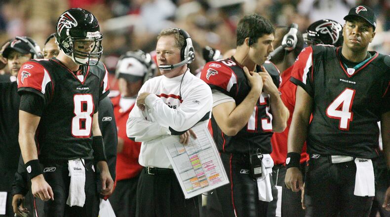 Falcons coach Bobby Petrino confers with quarterback Chris Redman (8) on the sidelines between plays as Joey Harrington (13) and Byron Leftwich (4) standby during fourth quarter Monday, Dec. 10, 2007, at the Georgia Dome in Atlanta. It was Petrino's last game as Falcons head coach.