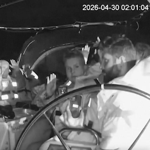 This grab from black and white CCTV footage shows members on flotilla boat with hands in air as Israeli forces intercepted activists who set sail earlier this month from Barcelona attempting to break Israel’s maritime blockade of Gaza, near the southern Greek island of Crete, early Thursday, April 30, 2026. (Global Sumud Flotilla via AP)