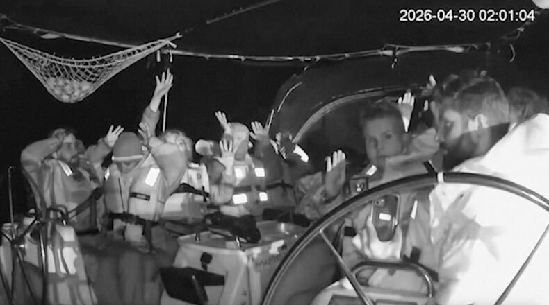 This grab from black and white CCTV footage shows members on flotilla boat with hands in air as Israeli forces intercepted activists who set sail earlier this month from Barcelona attempting to break Israel’s maritime blockade of Gaza, near the southern Greek island of Crete, early Thursday, April 30, 2026. (Global Sumud Flotilla via AP)