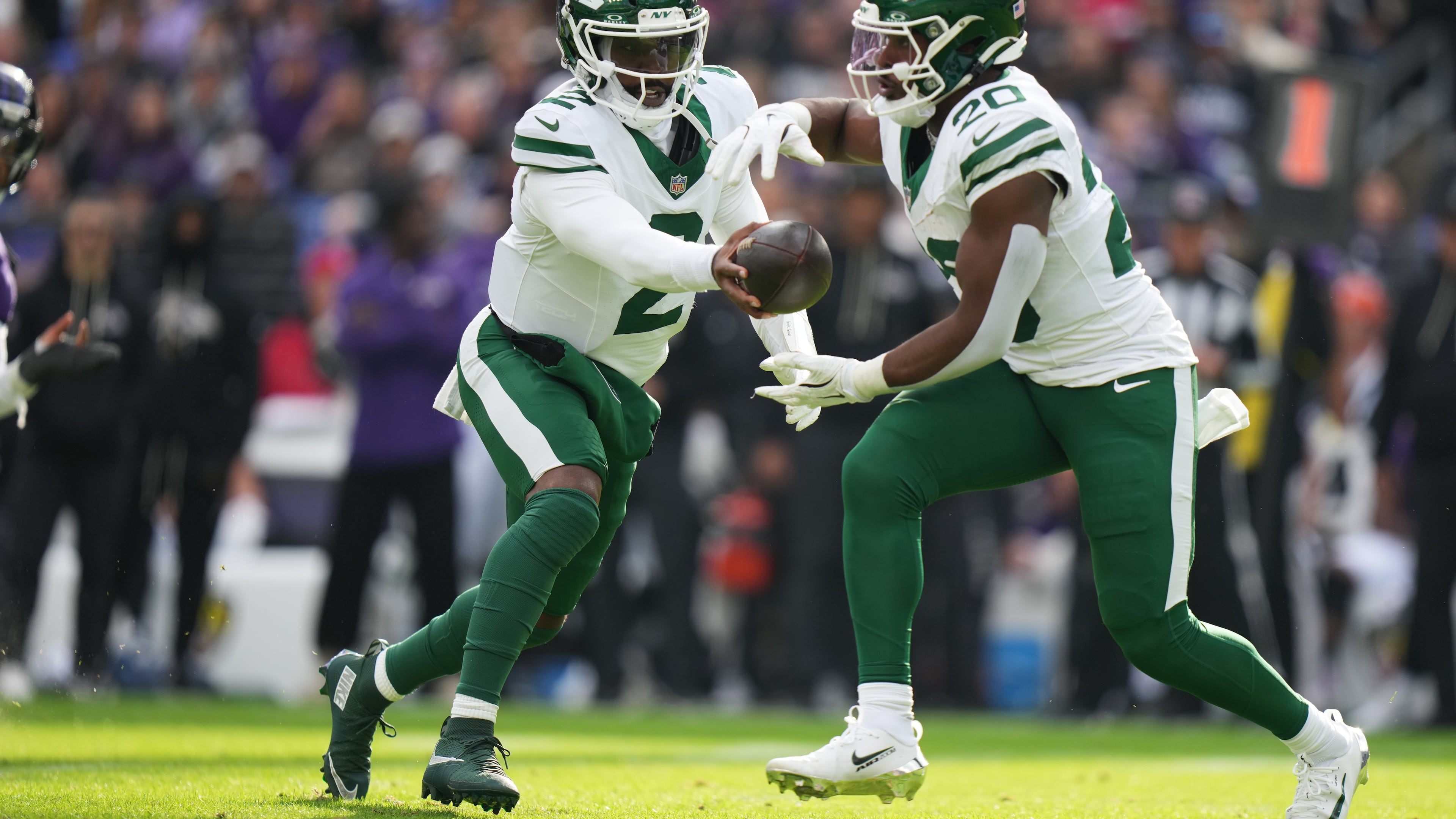 New York Jets quarterback Tyrod Taylor (2) hand off to running back Breece Hall (20) during the first half of an NFL football game against the Baltimore Ravens, Sunday, Nov. 23, 2025, in Baltimore. (AP Photo/Stephanie Scarbrough)
