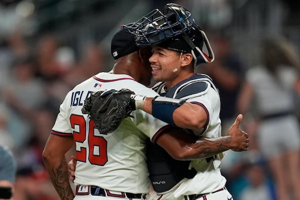 Raisel Iglesias (left, hugging catcher Drake Baldwin) even failed to blow a save. 