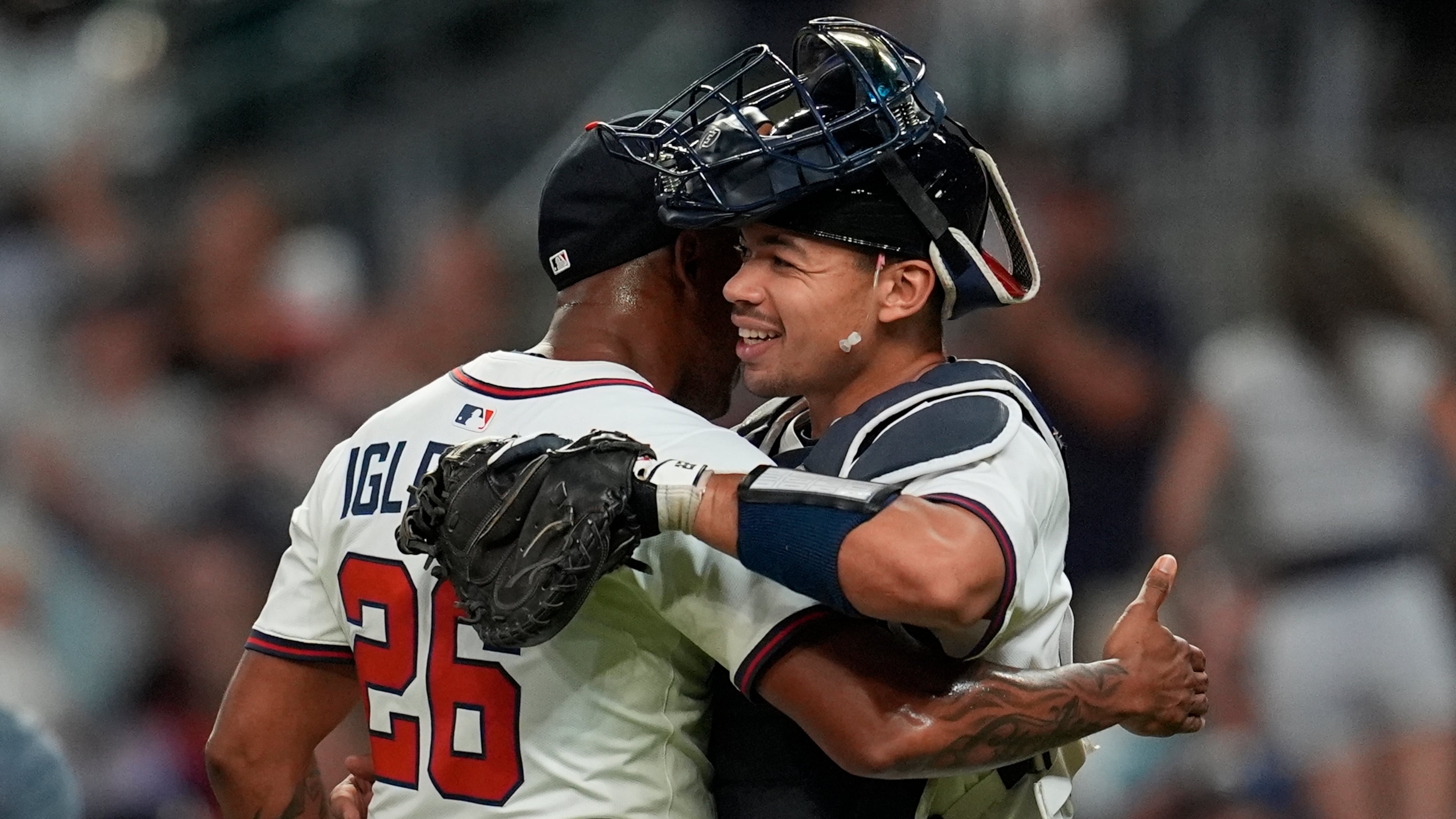 Atlanta Braves pitcher Raisel Iglesias (26) celebrates a win with Drake Baldwin (30) against the Miami Marlins after a baseball game, Thursday, Aug. 7, 2025, in Atlanta. (AP Photo/Mike Stewart)
