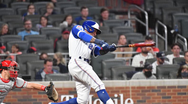 Braves infielder Ehire Adrianza (23) hits three run home run in the 6th inning Friday, April 9, 2021, against the Philadelphia Phillies in the 2021 home opener at Truist Park in Atlanta. (Hyosub Shin / Hyosub.Shin@ajc.com)