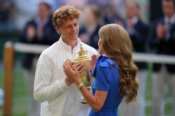 Italy's Jannik Sinner receives the trophy from Kate, Princess of Wales, after beating Carlos Alcaraz of Spain to win the men's singles final at the Wimbledon Tennis Championships in London, Sunday, July 13, 2025. (AP Photo/Kin Cheung)