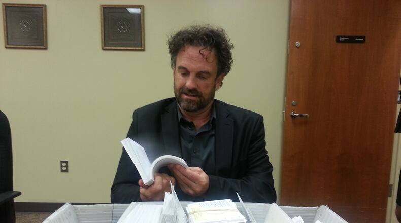 Fulton County Director of Elections and Registration Richard Barron flips through precinct cards that were returned to his office this spring. ARIELLE KASS/AJC File Photo