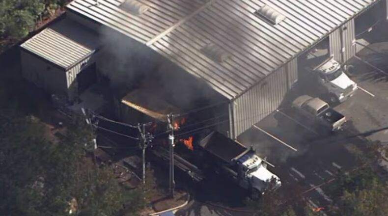 Two people were injured Monday after a fire broke out at a business in Cherokee County, officials said.