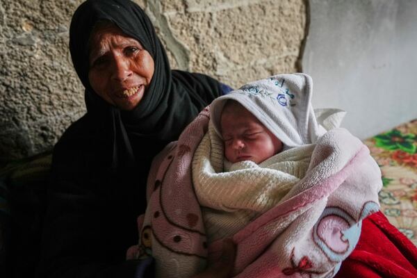 Ella Osama Abu Dagga, 25 days old, is held by her great-aunt Suad Abu Dagga after she was pulled from the rubble earlier following an Israeli army airstrike that killed her parents and brother in Khan Younis, southern Gaza Strip, Thursday, March 20, 2025. (AP Photo/Mariam Dagga)