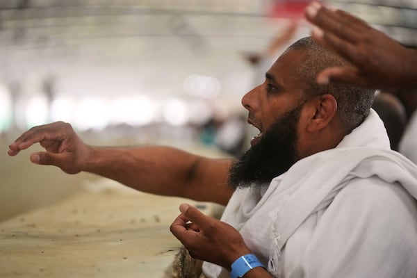A Muslim pilgrim casts stones at pillars in the symbolic stoning of the devil, the last rite of the annual Hajj, in Mina near the holy city of Mecca, Saudi Arabia, Friday, June 6, 2025. (AP Photo/Amr Nabil)