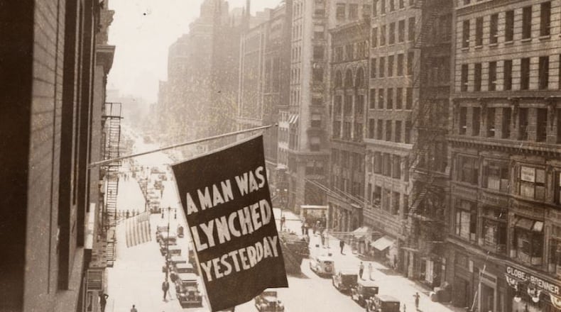 In this undated photo, a flag announcing lynching is flown from the window of the NAACP headquarters in New York City. Source: Library of Congress