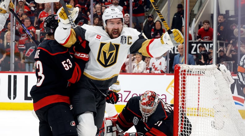 Vegas Golden Knights' Mark Stone (61) celebrates after his goal while in the grasp of Carolina Hurricanes' Jackson Blake (53) with Hurricanes goaltender Frederik Andersen, right, nearby during the third period in Game 2 of the NHL hockey Stanley Cup Final series in Raleigh, N.C., Thursday, June 4, 2026. (AP Photo/Karl DeBlaker)