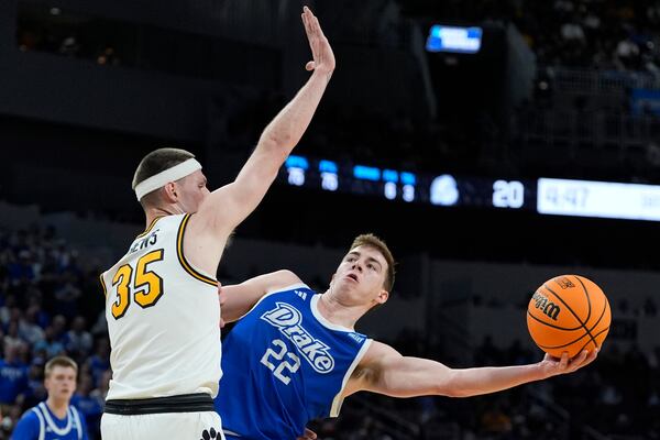 Drake guard Mitch Mascari (22) shoots around Missouri guard Jacob Crews (35) during the first half of the first round of the NCAA college basketball tournament, Thursday, March 20, 2025, in Wichita, Kan. (AP Photo/Charlie Riedel)