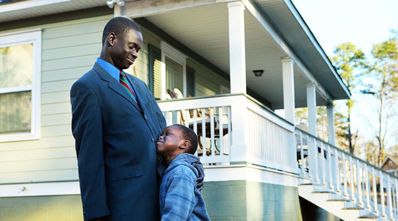 Jacob Mach gets a hug from his 6-year-old son Mach Mach after he arrives home from work on Wednesday, Jan. 8, 2014, in Atlanta. CURTIS COMPTON / CCOMPTON@AJC.COM