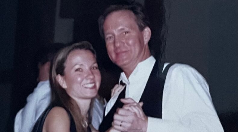 Writer Angela English Hansberger and her dad, Walter English, are seen dancing at a wedding. At her own wedding, they danced to "Sunshine on My Shoulder." Courtesy of Angela Hansberger