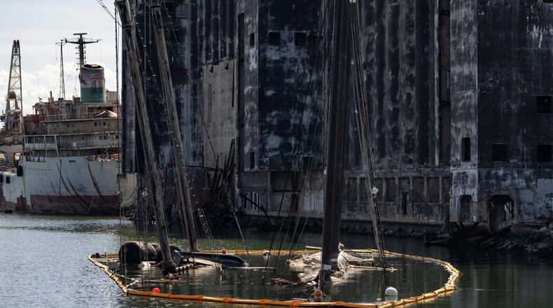 Debris of the Victory Chimes and the Pilot floats in the Henry Street Basin, Wednesday, Aug. 26, 2026, in the Brooklyn borough of New York. (AP Photo/Yuki Iwamura)