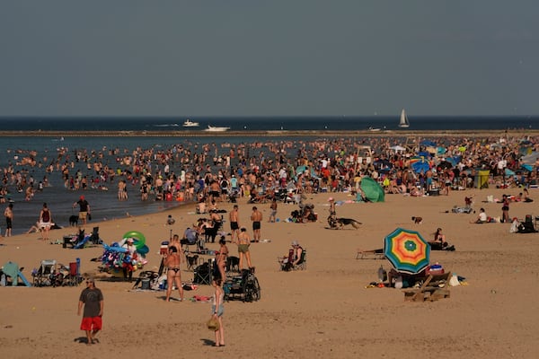 Beach goers crowd a public beach on the Lake Michigan shore, Sunday, June 22, 2025, in Chicago. (AP Photo/Kiichiro Sato)