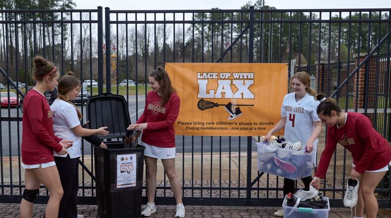 Members of the Johns Creek High girls lacrosse team have collected more than 600 shoes since they began an annual drive four years ago.