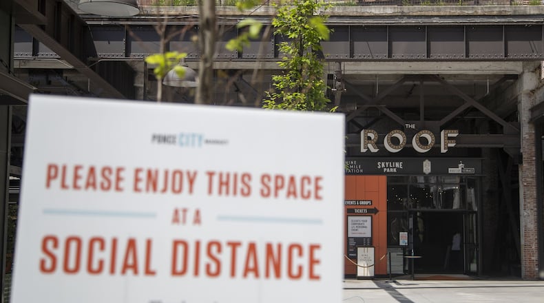 A sign encouraging social distancing is displayed at Ponce City Market in Atlanta’s Old Fourth Ward community May 4, 2020. ALYSSA POINTER / ALYSSA.POINTER@AJC.COM
