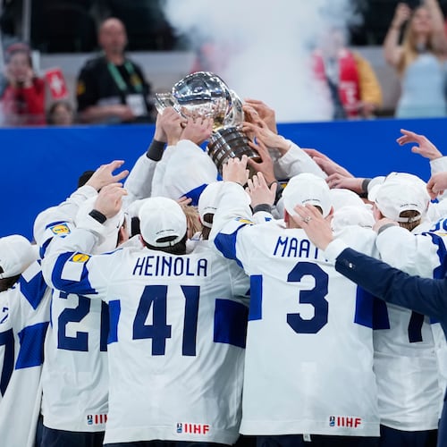 Finland players celebrate with trophy after winning the 2026 IIHF Men's Ice Hockey World Championship final match against Switzerland, in Zurich, Switzerland, Sunday, May 31, 2026. (AP Photo/Darko Bandic)