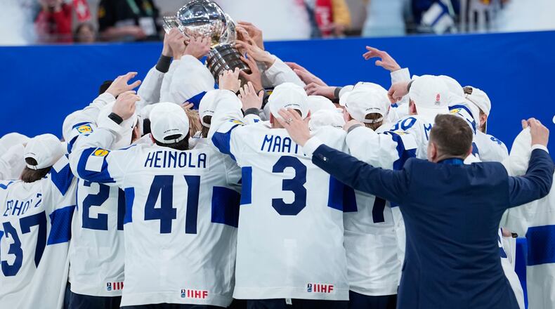 Finland players celebrate with trophy after winning the 2026 IIHF Men's Ice Hockey World Championship final match against Switzerland, in Zurich, Switzerland, Sunday, May 31, 2026. (AP Photo/Darko Bandic)