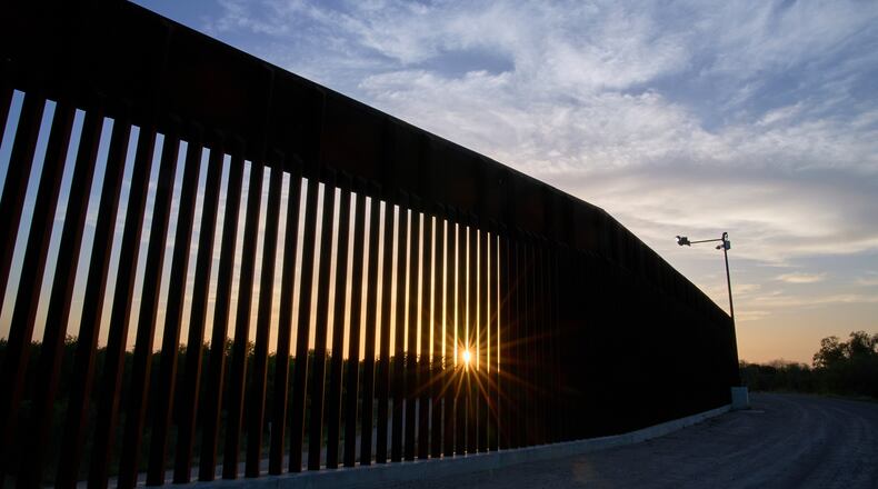 FILE - The sun sets over a section of the border wall, June 18, 2025, in Mission, Texas. (AP Photo/Jacquelyn Martin, File)