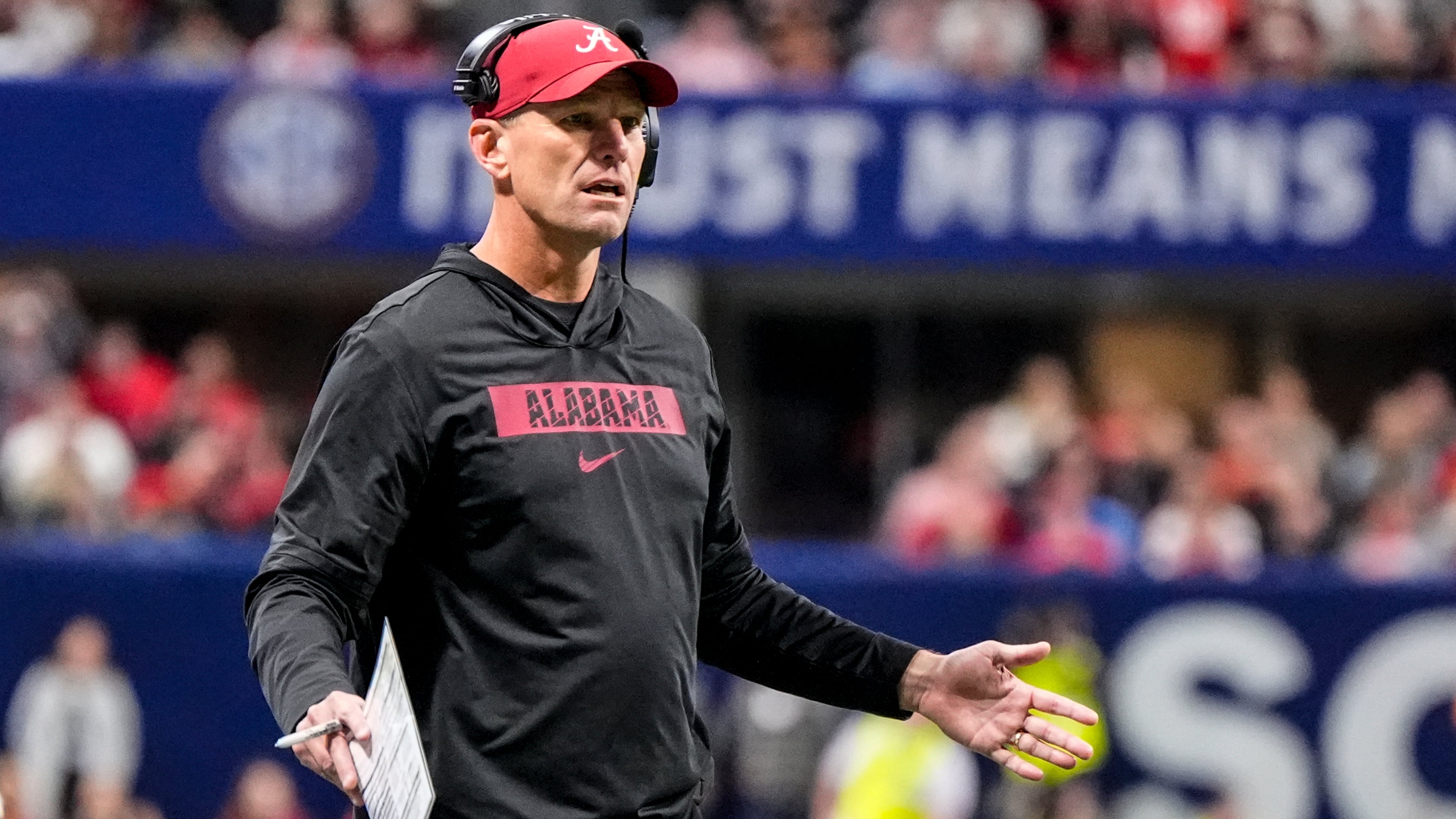 Alabama head coach Kalen Deboer speaks to an official during the first half of a Southeastern Conference championship NCAA college football game between Georgia and Alabama, Saturday, Dec. 6, 2025, in Atlanta. (AP Photo/Mike Stewart)